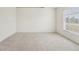 Bedroom with neutral walls, carpet flooring, and a bright window at 12124 Colonial Estates Ln, Riverview, FL 33579