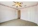 Comfortable bedroom features a ceiling fan, closet, carpeted floor, and a window with plenty of natural light at 12124 Colonial Estates Ln, Riverview, FL 33579