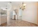 Dining area with tile flooring and chandelier, flowing into the kitchen at 12124 Colonial Estates Ln, Riverview, FL 33579