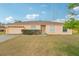 Charming single-story home features a well-maintained front yard and a classic exterior design at 12124 Colonial Estates Ln, Riverview, FL 33579