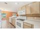 Charming kitchen featuring white appliances, tile backsplash, and tile floor at 12124 Colonial Estates Ln, Riverview, FL 33579