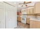 Cozy kitchen with white appliances, tile backsplash, and tile floor at 12124 Colonial Estates Ln, Riverview, FL 33579