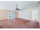Open living room featuring a ceiling fan, French doors, and neutral walls at 12124 Colonial Estates Ln, Riverview, FL 33579