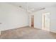 Main bedroom with fan, walk-in closet, and ensuite bathroom entrances at 12124 Colonial Estates Ln, Riverview, FL 33579