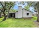 Exterior view of home with large backyard and lush landscaping at 14 Idlewilde Dr, Safety Harbor, FL 34695