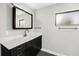 Bathroom featuring a sleek vanity with a marble countertop, modern fixtures, and stylish dark wood cabinets at 14 Idlewilde Dr, Safety Harbor, FL 34695