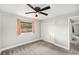 Cozy bedroom features a ceiling fan, closet, window, and neutral color palette at 14 Idlewilde Dr, Safety Harbor, FL 34695