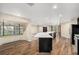 Bright, open kitchen with a large island, hardwood floors, and bay window, seamlessly blending with the living and dining spaces at 14 Idlewilde Dr, Safety Harbor, FL 34695