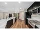 Bright kitchen with stainless steel appliances, dark cabinetry, and a large island with a white countertop at 14 Idlewilde Dr, Safety Harbor, FL 34695
