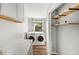 Laundry room with washer, dryer, and storage at 14 Idlewilde Dr, Safety Harbor, FL 34695