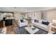 Inviting living area with hardwood floors, an open-concept design connecting the kitchen, dining area, and stylish living room at 14 Idlewilde Dr, Safety Harbor, FL 34695