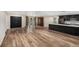 Expansive living area with hardwood floors, opening to a modern kitchen with an island, and stylish double front doors at 14 Idlewilde Dr, Safety Harbor, FL 34695