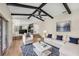 Cozy living room with hardwood floors, stylish furniture, and open access to a modern kitchen, creating an inviting and open space at 14 Idlewilde Dr, Safety Harbor, FL 34695