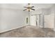 Spacious bedroom with neutral walls and a large closet featuring a modern sliding barn door at 14 Idlewilde Dr, Safety Harbor, FL 34695