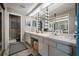 Bright bathroom with double vanity, decorative mirrors, and updated fixtures in neutral tones at 15344 E Pond Woods Dr, Tampa, FL 33618