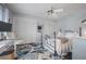 Light-blue bedroom featuring floral rug, bed, ceiling fan, mirrored closet doors and workspace at 15344 E Pond Woods Dr, Tampa, FL 33618