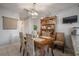 Bright dining room with tile floor, hutch, stylish lighting, and ample seating at 15344 E Pond Woods Dr, Tampa, FL 33618
