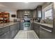 Modern kitchen with stainless steel appliances, granite countertops, and custom cabinets at 15344 E Pond Woods Dr, Tampa, FL 33618