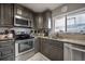 Well-equipped kitchen featuring stainless steel appliances, granite counters, and ample storage at 15344 E Pond Woods Dr, Tampa, FL 33618