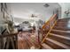 Cozy living room with hardwood floors, fan, staircase, and comfortable furnishings at 15344 E Pond Woods Dr, Tampa, FL 33618
