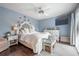 Serene main bedroom with hardwood floors, natural light, and calming blue walls at 15344 E Pond Woods Dr, Tampa, FL 33618