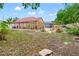 Expansive backyard featuring a brick patio, screened-in pool enclosure, and lush landscaping, ideal for outdoor enjoyment at 18005 Palm Breeze Dr, Tampa, FL 33647