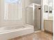 Bathroom featuring a soaking tub and separate glass enclosed shower at 18005 Palm Breeze Dr, Tampa, FL 33647