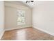 Bright bedroom features tile flooring, fresh paint, large window, and neutral decor at 18005 Palm Breeze Dr, Tampa, FL 33647