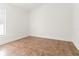 Bright, empty bedroom features neutral decor and tile floors, awaiting personalization at 18005 Palm Breeze Dr, Tampa, FL 33647