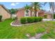 Charming home exterior with manicured landscaping and palm trees, offering great curb appeal in a residential neighborhood at 18005 Palm Breeze Dr, Tampa, FL 33647