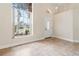 Bright foyer showcasing a front door with oval window, light tile flooring, and ample natural light at 18005 Palm Breeze Dr, Tampa, FL 33647
