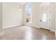 Bright foyer featuring tiled flooring, a chandelier, and a front door with a large arched window at 18005 Palm Breeze Dr, Tampa, FL 33647