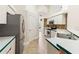 Kitchen featuring white cabinets, stainless steel appliances, and tile backsplash at 18005 Palm Breeze Dr, Tampa, FL 33647