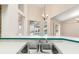 Kitchen island with a double sink looking out into the living room and pool at 18005 Palm Breeze Dr, Tampa, FL 33647