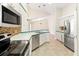 Eat-in kitchen with stainless steel appliances and modern tile backsplash at 18005 Palm Breeze Dr, Tampa, FL 33647