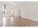 Spacious living room with light tile flooring, neutral walls, a chandelier and front door with arched window at 18005 Palm Breeze Dr, Tampa, FL 33647