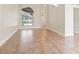 Spacious living room with light tile flooring, neutral walls, and views of the pool area at 18005 Palm Breeze Dr, Tampa, FL 33647