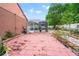 View of the brick patio leading to the screened-in pool area, perfect for relaxing and entertaining outdoors at 18005 Palm Breeze Dr, Tampa, FL 33647