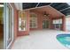 Covered patio with pool views showcases seamless indoor/outdoor living and entertaining space at 18005 Palm Breeze Dr, Tampa, FL 33647