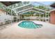 Sparkling screened-in pool with easy access and lush landscaping provides a private retreat at 18005 Palm Breeze Dr, Tampa, FL 33647