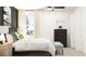This bedroom features a view from the window, ceiling fan, chest of drawers, and accent wall at 1810 Tropical Oasis Ave, Plant City, FL 33565