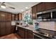 Well-appointed kitchen featuring tile backsplash, ample cabinet space, and stainless steel appliances at 2049 Broadway, Clearwater, FL 33755