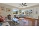 Bright living room with hardwood floors, a neutral palette, and several windows offering exterior views at 2049 Broadway, Clearwater, FL 33755