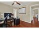 Bright office features hardwood floors, a large window and a framed map at 2049 Broadway, Clearwater, FL 33755