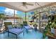 Relaxing sunroom with lounge chairs overlooking the backyard at 2049 Broadway, Clearwater, FL 33755