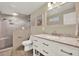 Modern bathroom featuring a walk-in shower, white vanity with marble countertop, and neutral color palette at 2049 Broadway, Clearwater, FL 33755