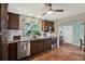 Traditional kitchen with stainless steel appliances, granite countertops, and a view of the yard at 2049 Broadway, Clearwater, FL 33755