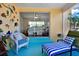 Inviting sunroom with colorful decor, comfortable seating, and access to another room at 2049 Broadway, Clearwater, FL 33755