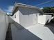 Backyard area with a newly painted exterior, a white fence and painted concrete at 2117 W Clifton St, Tampa, FL 33603