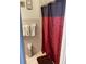 Bathroom with a red patterned shower curtain and tiled walls at 2117 W Clifton St, Tampa, FL 33603